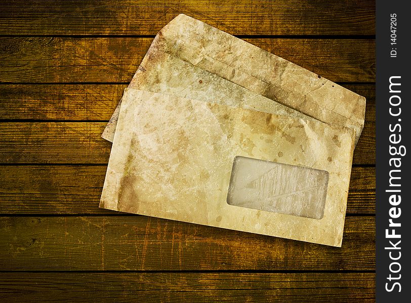 Old envelopes with some spots on a wooden background
