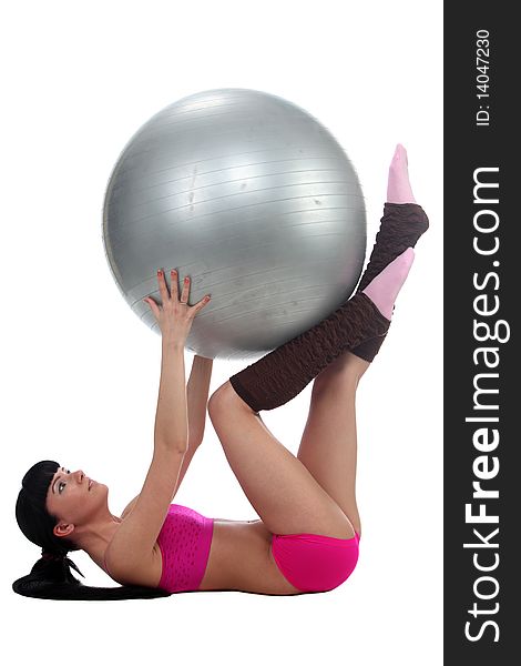 Attractive brunete girl doing gymnastic excersises with a ball. Attractive brunete girl doing gymnastic excersises with a ball