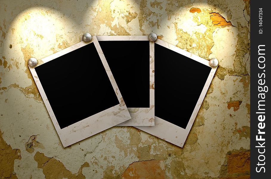 Three empty grunge frame for your photo on the old wall with lighting