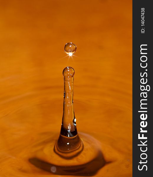 Water drop on orange background