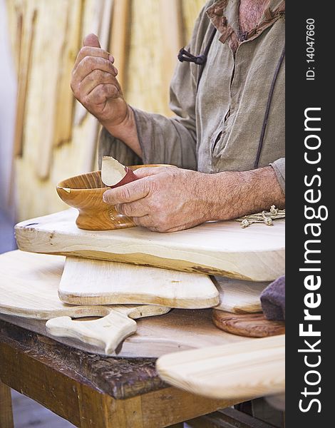 Craftsman works a wooden bowl. Craftsman works a wooden bowl