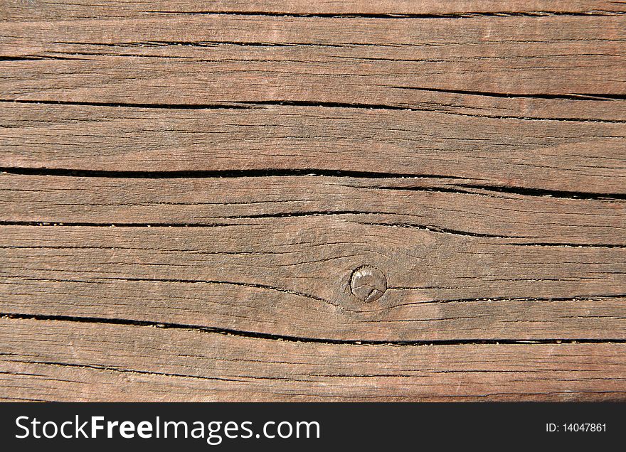 Pinkish wooden texture with crakcs