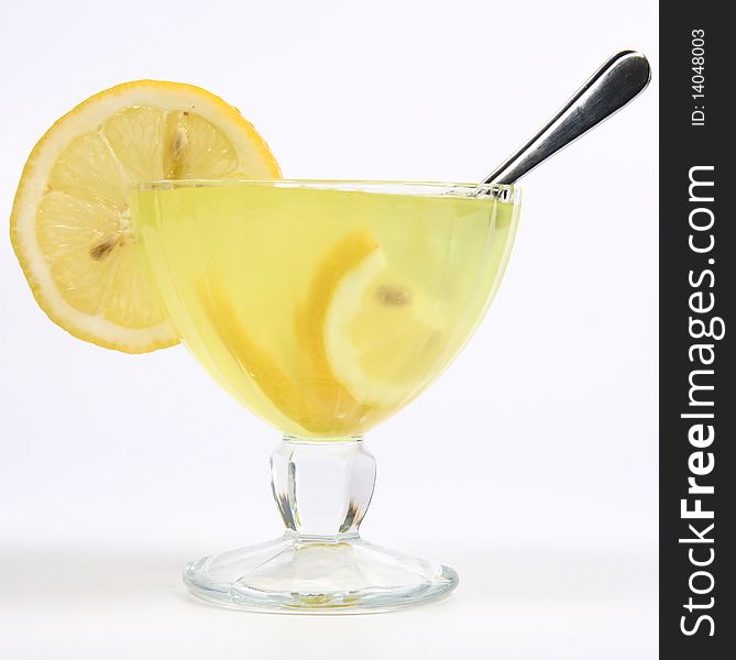 Lemon fruit cream with lemon slices in a glass cup