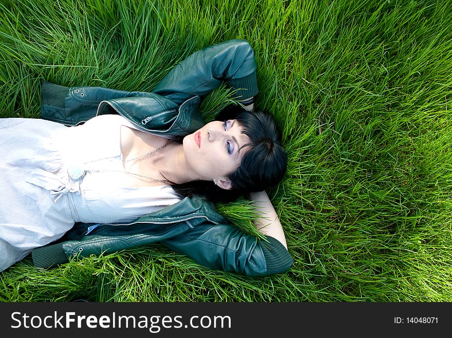 Young model laying in the grass. Young model laying in the grass