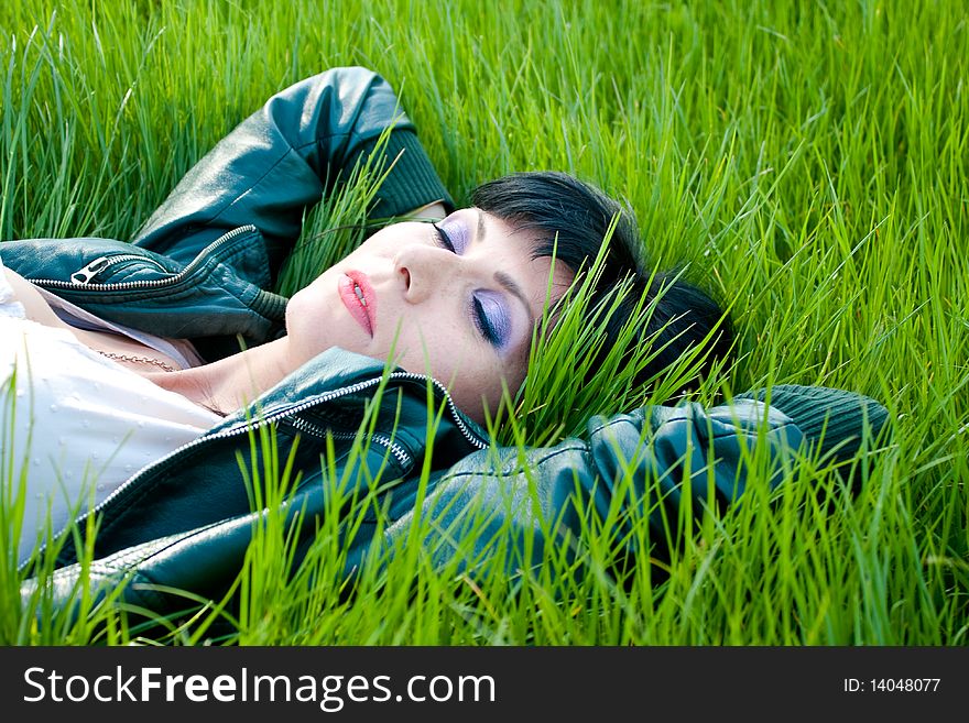Young model laying in the grass. Young model laying in the grass