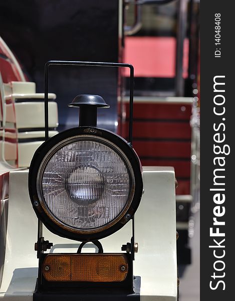 A completed head light of a small train in red and white color, and interesting shape. A completed head light of a small train in red and white color, and interesting shape.