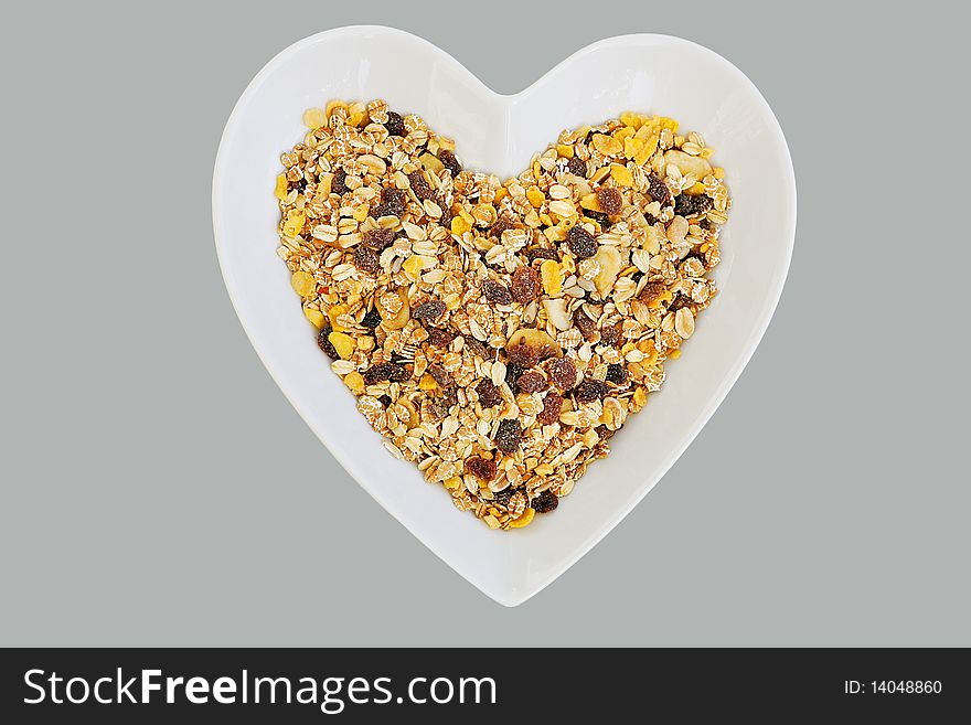 Heart shaped dish with healthy muesli breakfast. Heart shaped dish with healthy muesli breakfast