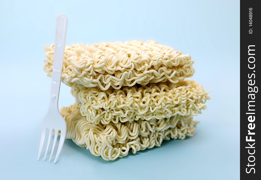 Dry instant noodles isolated against a blue background