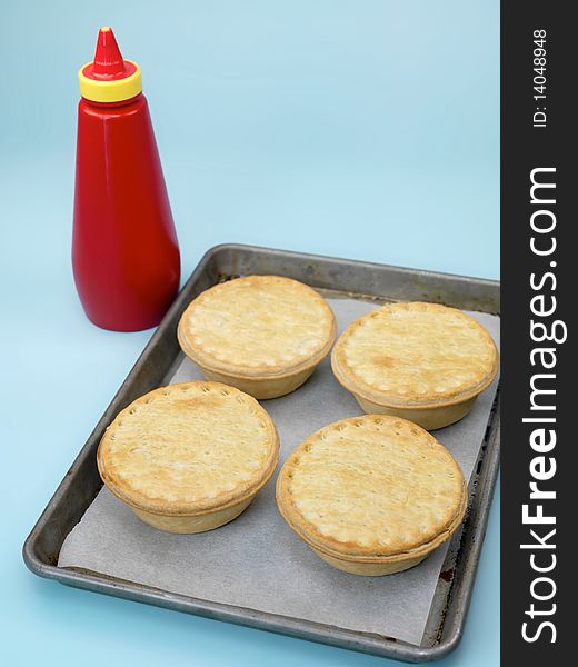 Australian meat pies isolated on a baking tray