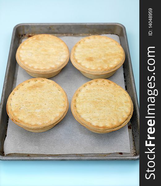 Australian meat pies isolated on a baking tray