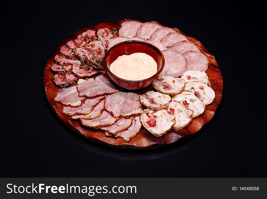 Meat plate on a black background.