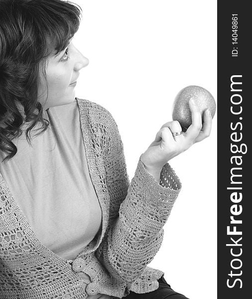 Beautiful girl holding apple and looks aside, black-and-white. Beautiful girl holding apple and looks aside, black-and-white