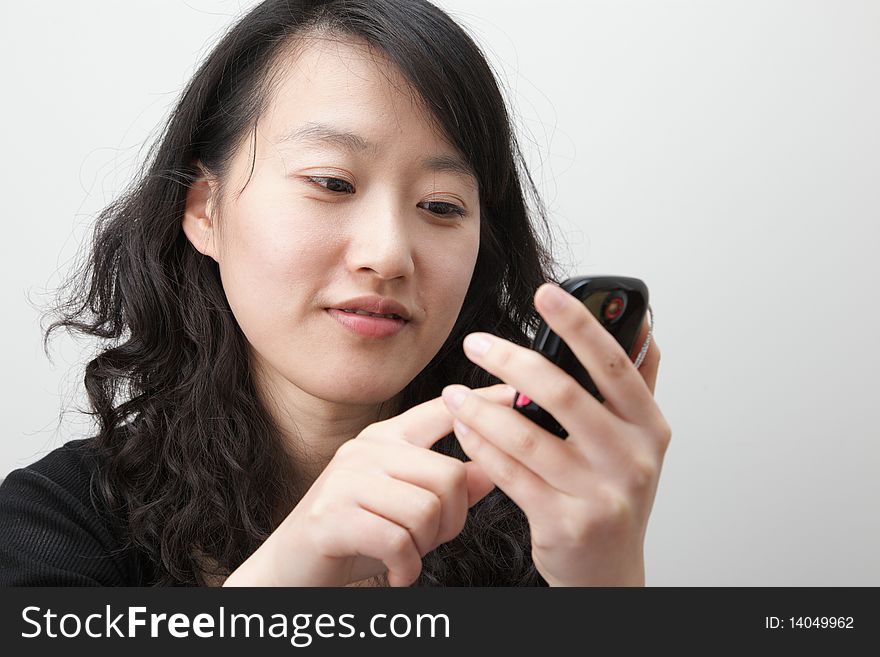 Attractive young lady with a tough screen cellphone