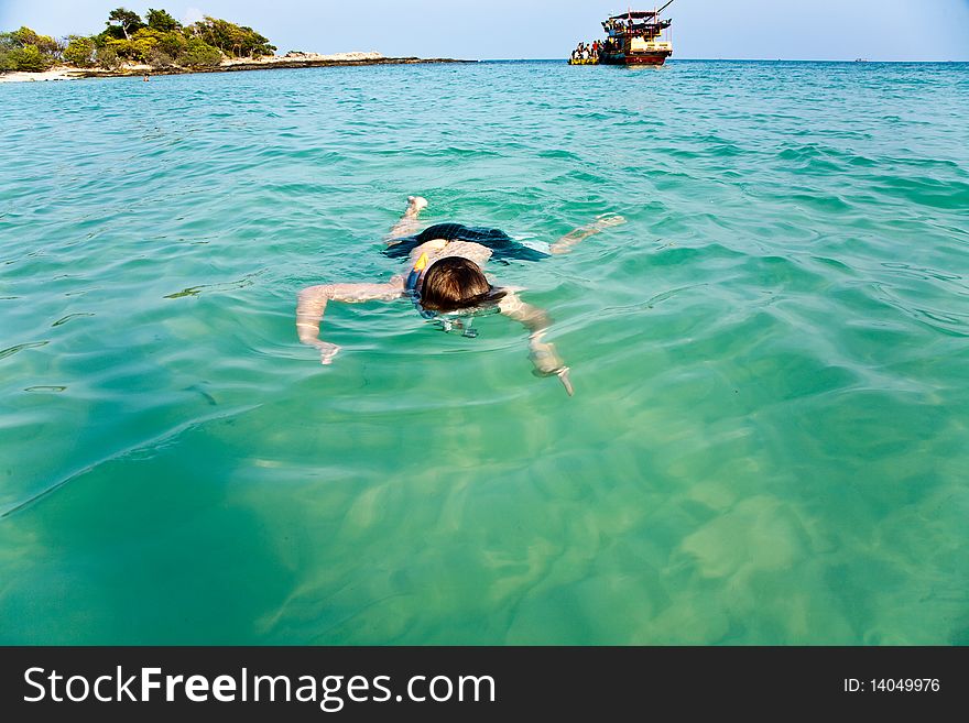 Young boy likes to snorkel in the clear water at the beautiful beach. Young boy likes to snorkel in the clear water at the beautiful beach