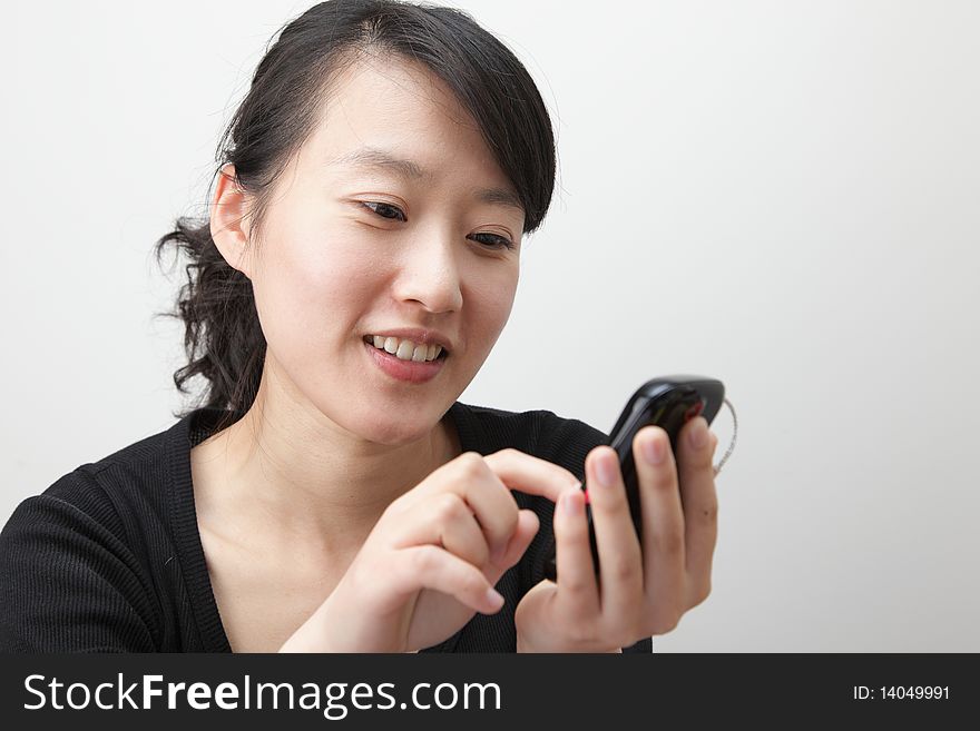 Attractive young lady with a tough screen cellphone