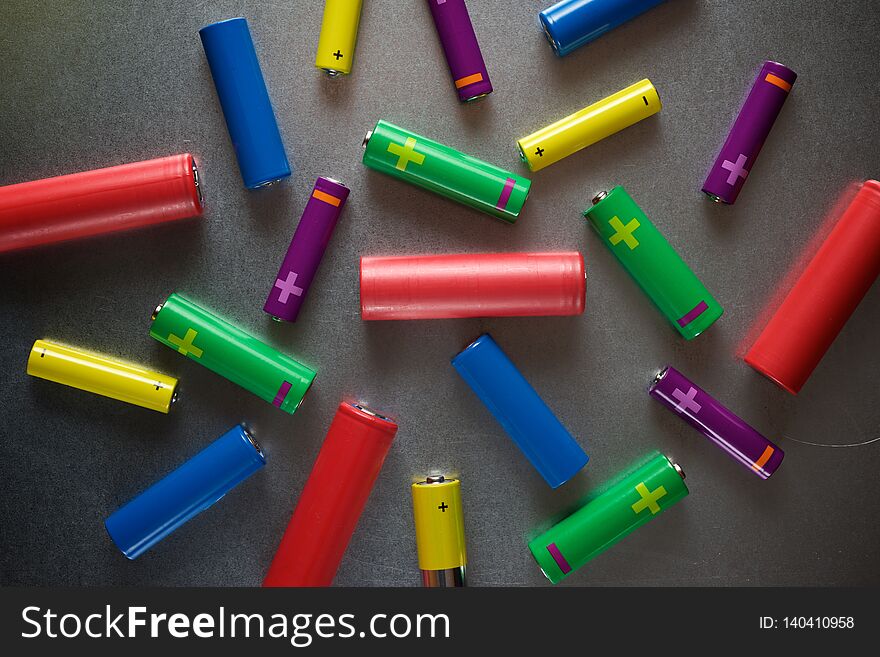 Many batteries on a metal table. Many batteries on a metal table