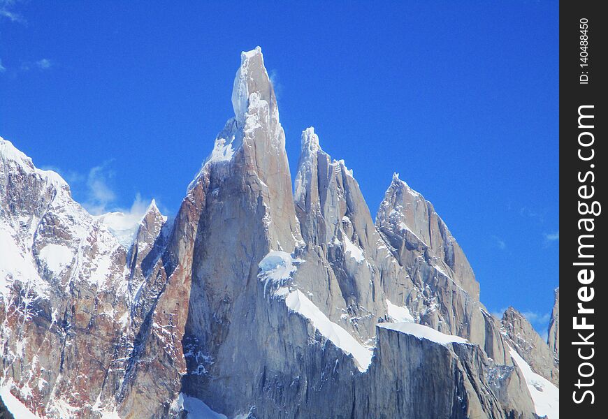 Cerro Torre is one of the mountains of the Southern Patagonian Ice Field in South America. It is located in a region which was disputed between Argentina and Chile, west of Fitz Roy also known as Cerro Chaltén. The peak is the highest of a four mountain chain: the other peaks are Torre Egger 2,685 m 8,809 ft, Punta Herron, and Cerro Standhardt. The top of the mountain often has a mushroom of rime ice, formed by the constant strong winds, increasing the difficulty of reaching the actual summit. Cerro Torre is one of the mountains of the Southern Patagonian Ice Field in South America. It is located in a region which was disputed between Argentina and Chile, west of Fitz Roy also known as Cerro Chaltén. The peak is the highest of a four mountain chain: the other peaks are Torre Egger 2,685 m 8,809 ft, Punta Herron, and Cerro Standhardt. The top of the mountain often has a mushroom of rime ice, formed by the constant strong winds, increasing the difficulty of reaching the actual summit.