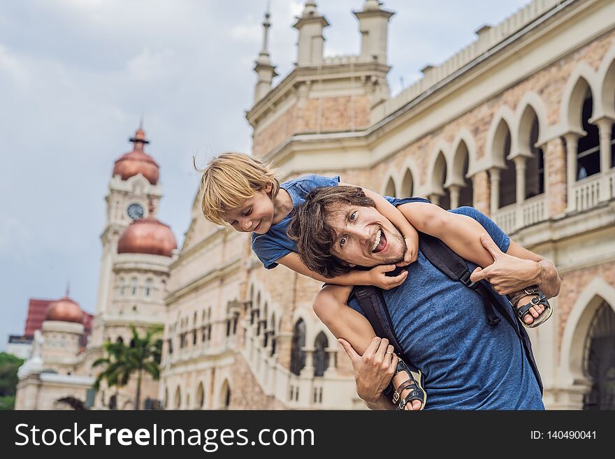 Dad and son on background of Sultan Abdul Samad Building in Kuala Lumpur, Malaysia. Traveling with children concept.