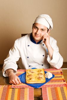 Handsome Young Chef In The Living Room With Cake O Royalty Free Stock Images Handsome Young Chef In The Living Room With Cake O Royalty Free Stock Images