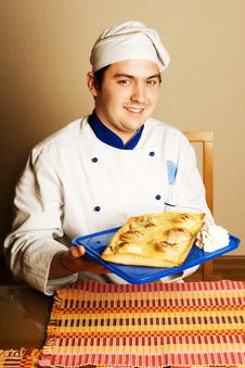 Handsome Young Chef In The Living Room With Cake O Royalty Free Stock Photo Handsome Young Chef In The Living Room With Cake O Royalty Free Stock Photo