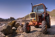 Old, Rusty Tractor On A Pebble Beach Stock Photography Old, Rusty Tractor On A Pebble Beach Stock Photography