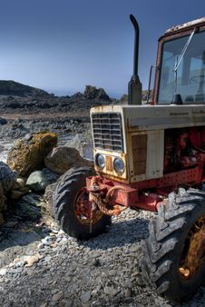 Frontside Of Old, Rusty Tractor On A Pebble Beach Stock Image Frontside Of Old, Rusty Tractor On A Pebble Beach Stock Image
