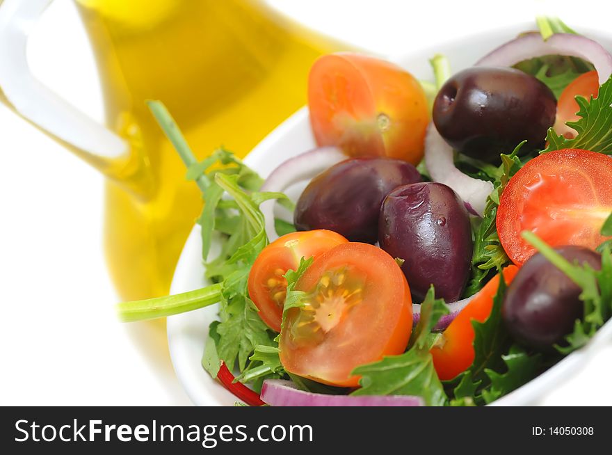 Salad with cherry tomatoes, onion and olives -white background