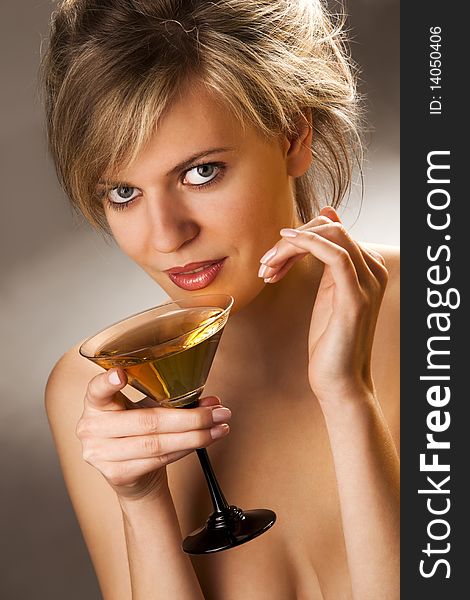 Beautiful alluring woman with glass of cocktail