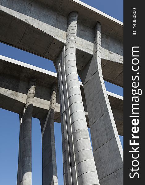 Close up view to the columns of the new highway bridge close to Prague. Low angle view, wide angle lens. Blue sky.