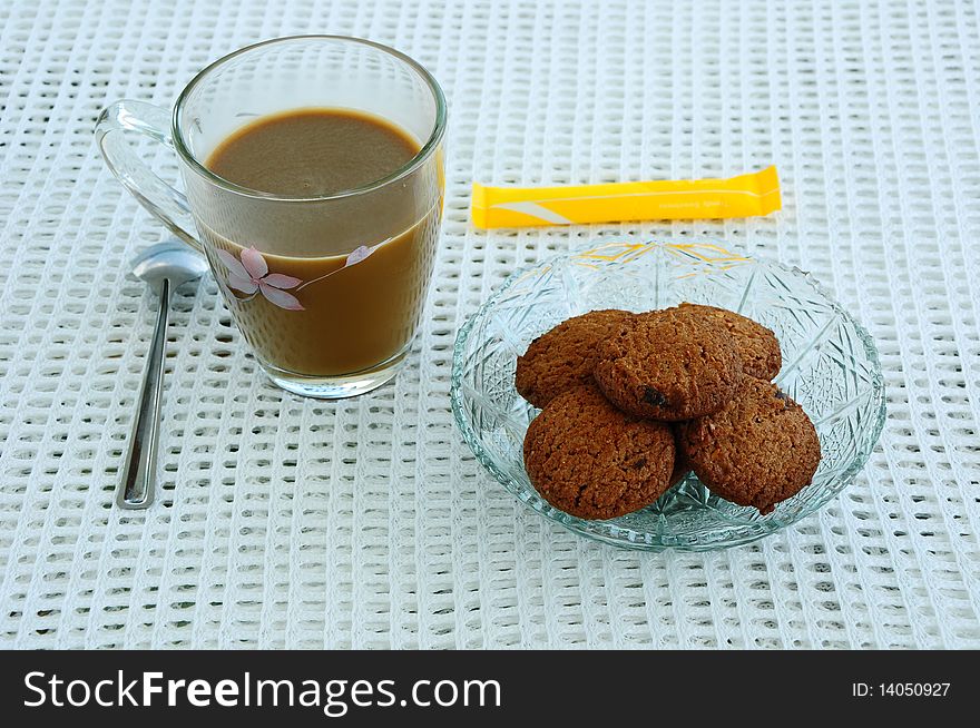 A cup of coffee and cookies. A cup of coffee and cookies.