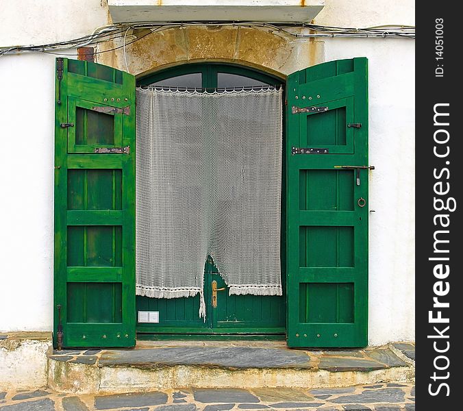 Old green door with shutters, Cadaques village, Costa Brava, Spain. Old green door with shutters, Cadaques village, Costa Brava, Spain