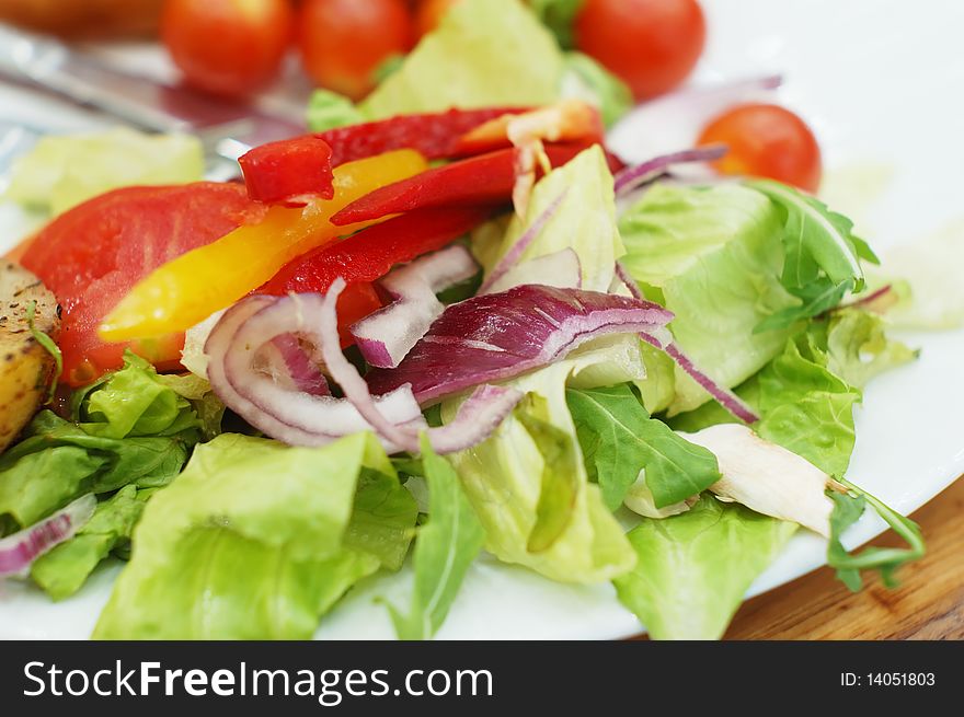 Fresh vegetable salad on white plate