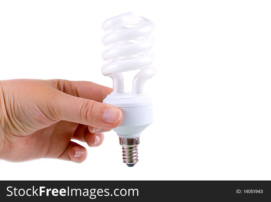 Energy-saving lamp in a hand on a white background