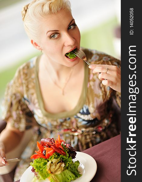 Woman Eating Salad In A Restaurant