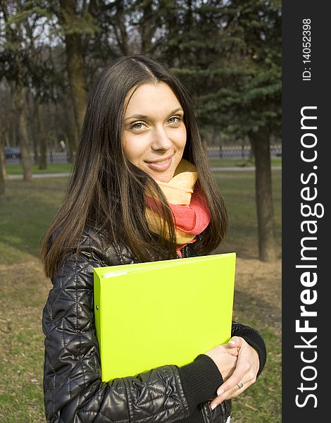 Beautiful elegant female walking in the park with folders documents. Beautiful elegant female walking in the park with folders documents