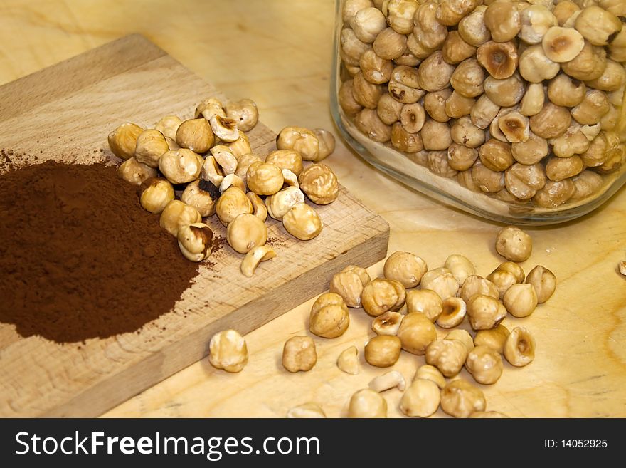 Cocoa and hazelnuts on a chopping board