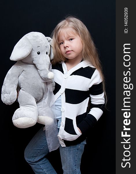 Little girl holds toy like elephant. Little girl holds toy like elephant