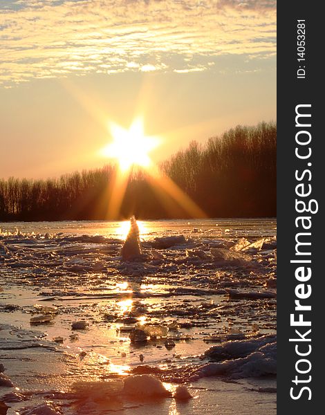 The big piece of ice floats on the river, sunset. The big piece of ice floats on the river, sunset