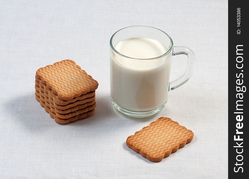 Glass cup of milk and cookies on table