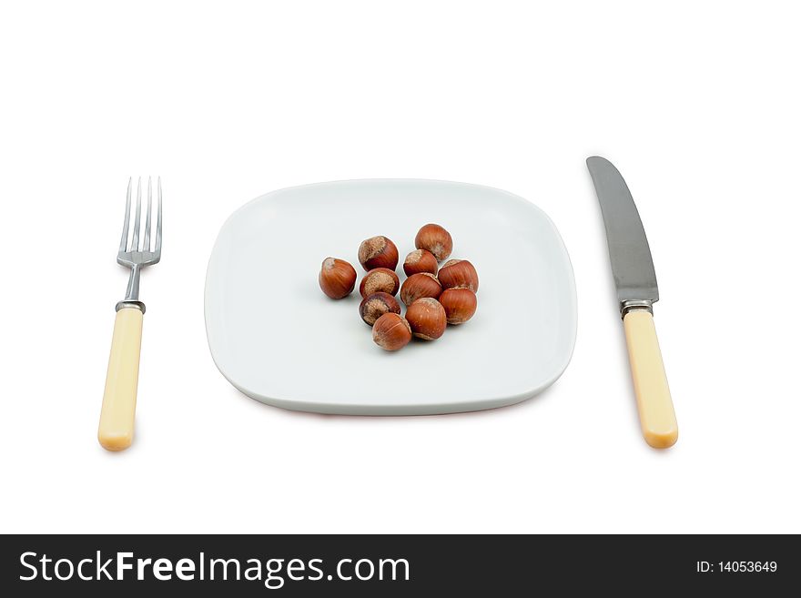 Knife, plug and plate with nuts on white bacground