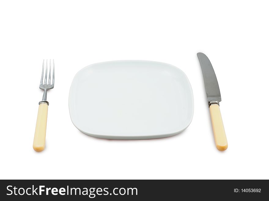 Knife, plug and empty plate on wite background