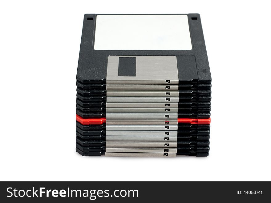 Stack of black floppy disks and one red on white background