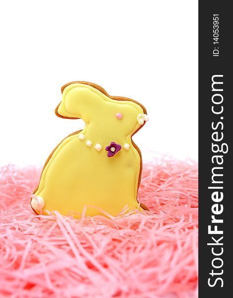 Close up of easter bunny cookies on pink ribbons over white background.