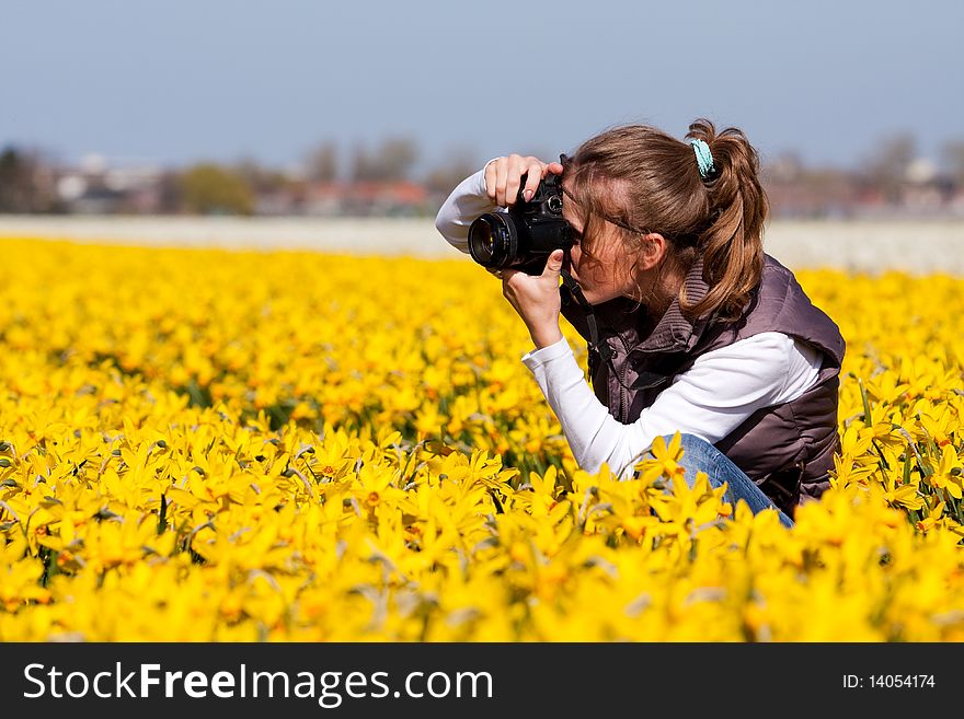 Girl photographer making pictures of flowers. Spring in the Netherlands. Girl photographer making pictures of flowers. Spring in the Netherlands