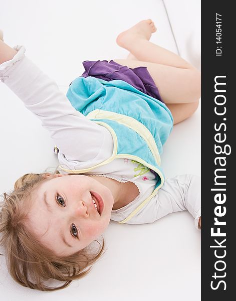 Happy little girl on white sofa. Happy little girl on white sofa