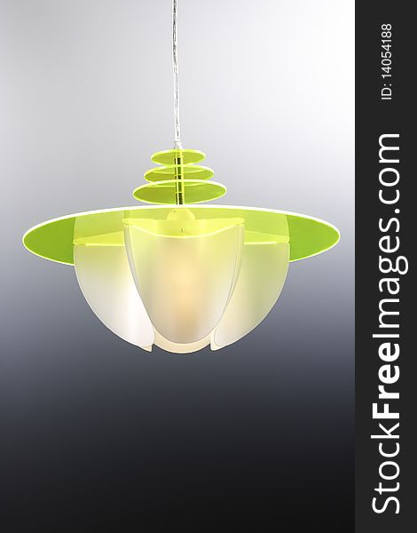 green plastic modem chandelier on gray background