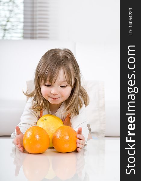 Happy little girl with fruits