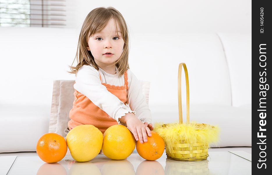 Happy little girl with fruits