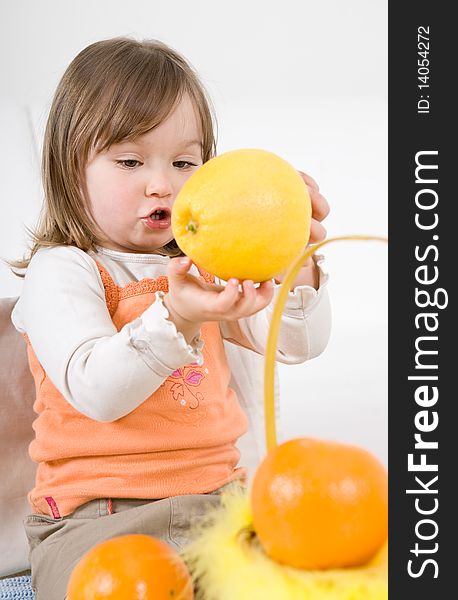 Happy little girl with fruits