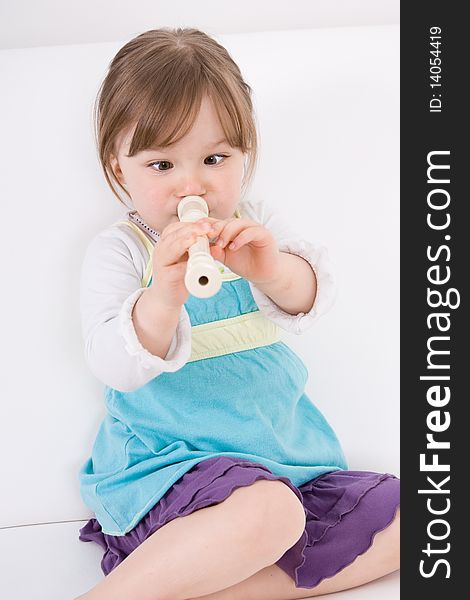 Little happy girl with flute